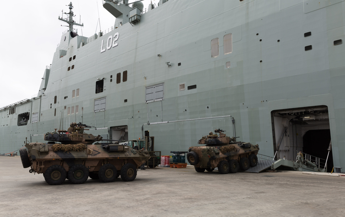 Tanks driving into the hold of <em>HMAS Canberra III</em>