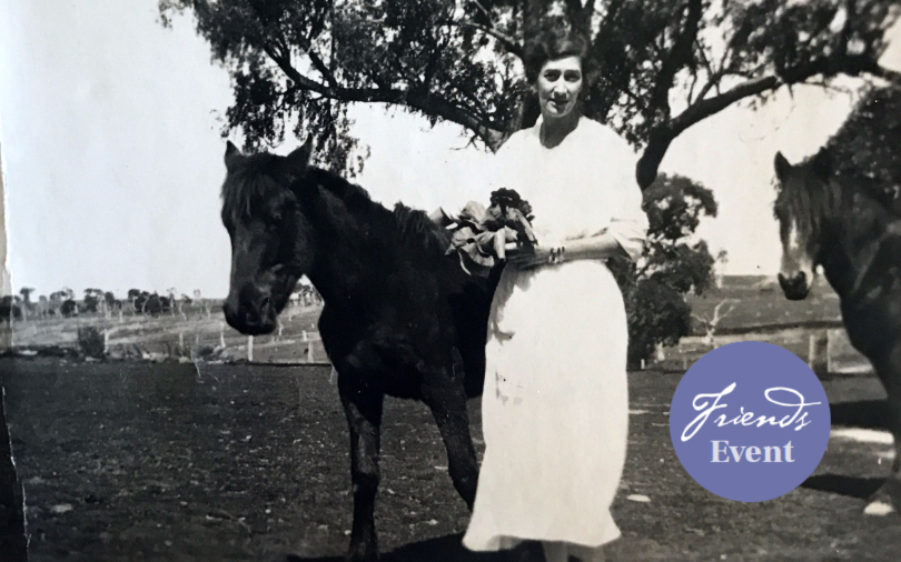 A sepia photograph of a woman with her horses.