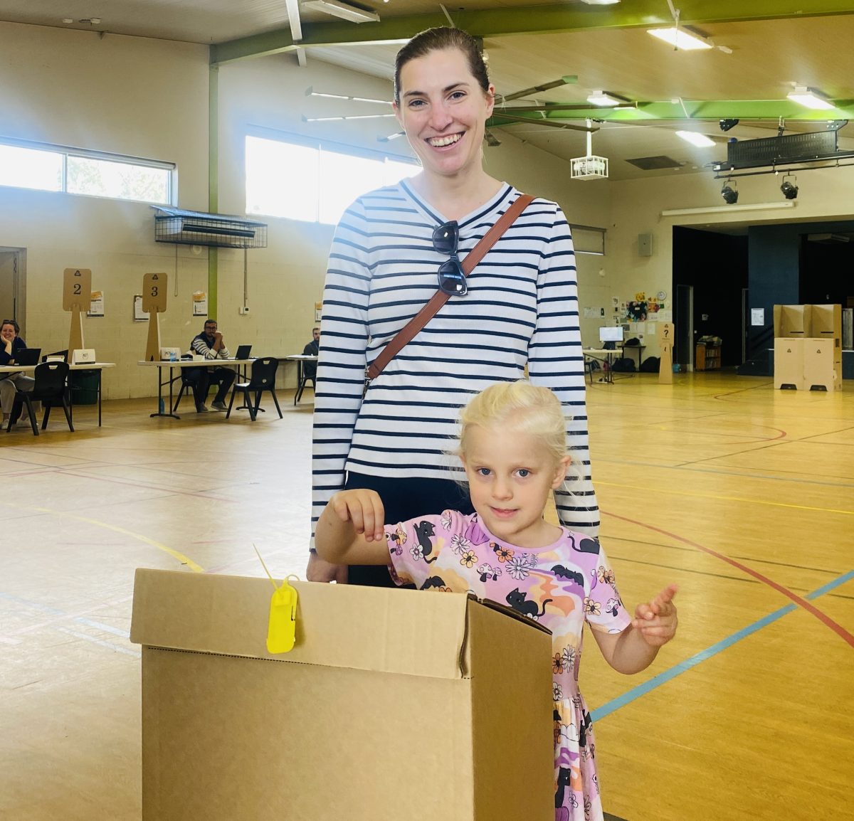 mum and daughter voting at election