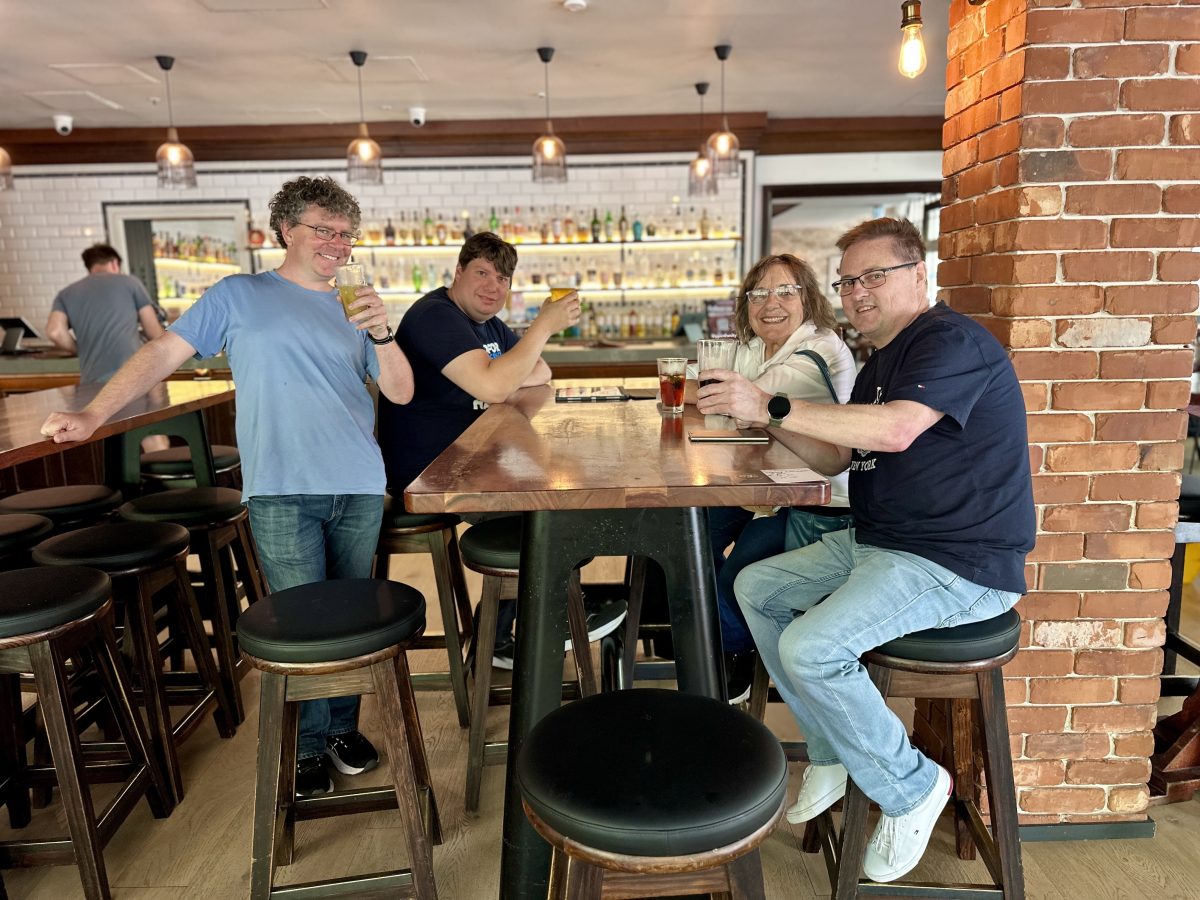 four people drinking beer