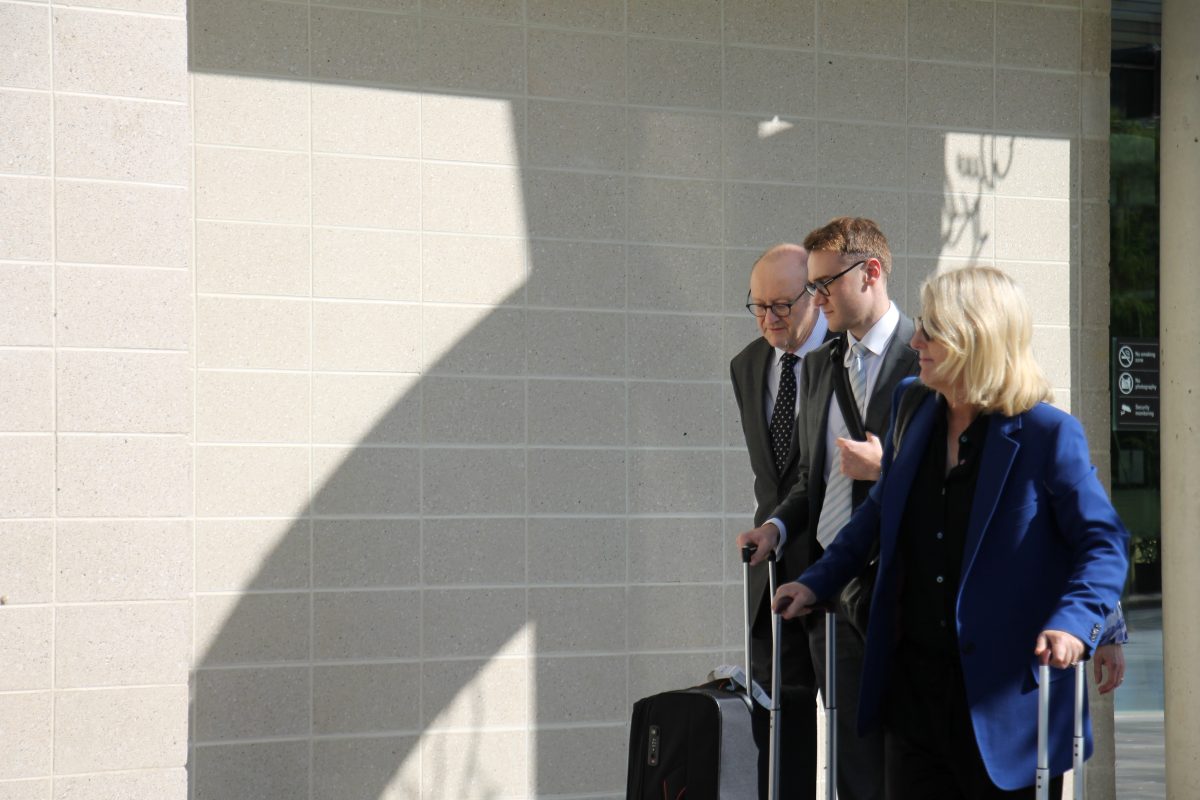 Two men and a woman leaving court