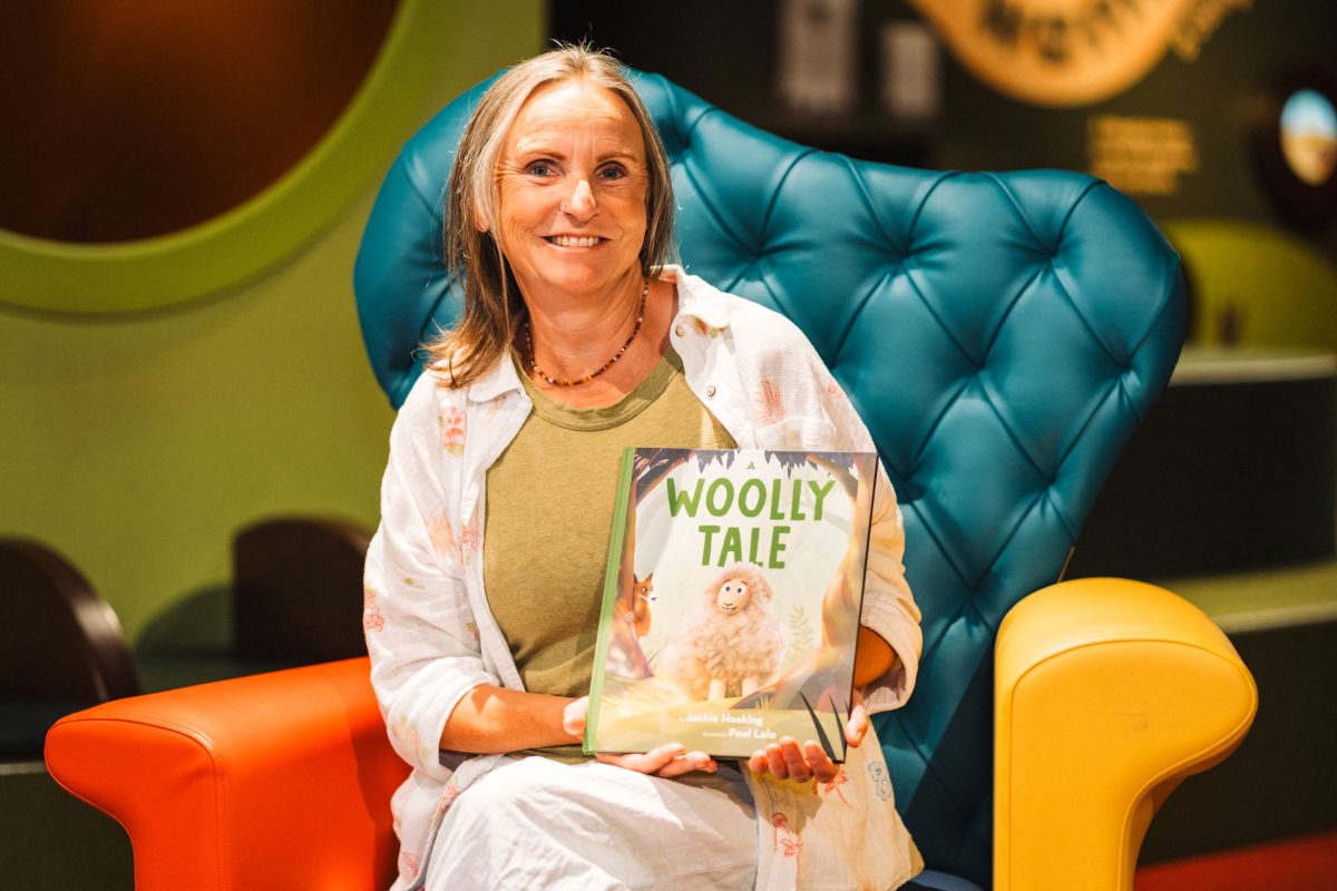 woman holding book called Woolly Tale