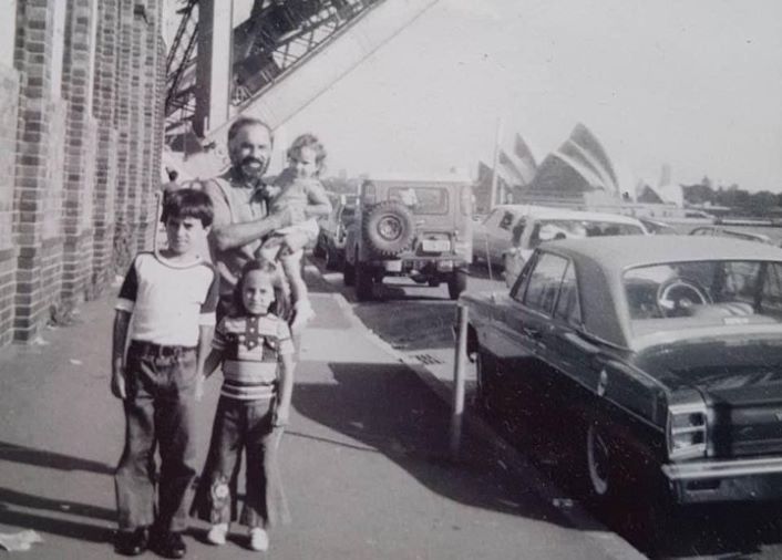 A sepia photograph of a father and his children.