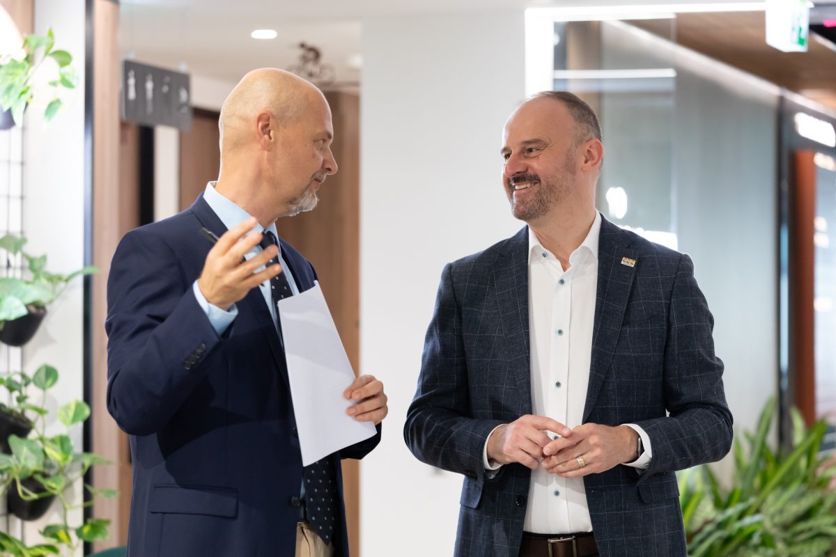 two men speaking in an office building