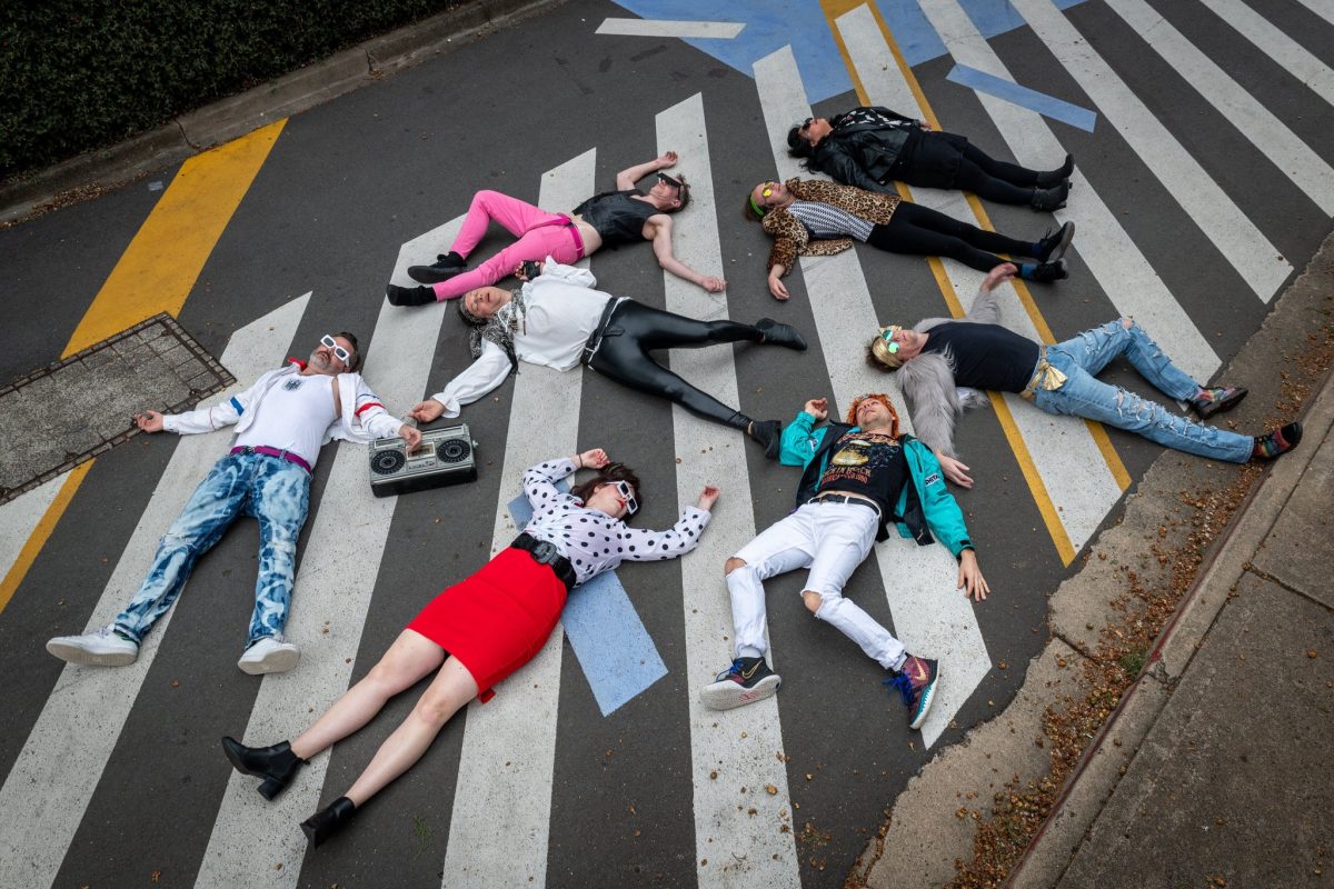 people lying down on a pedestrian crossing