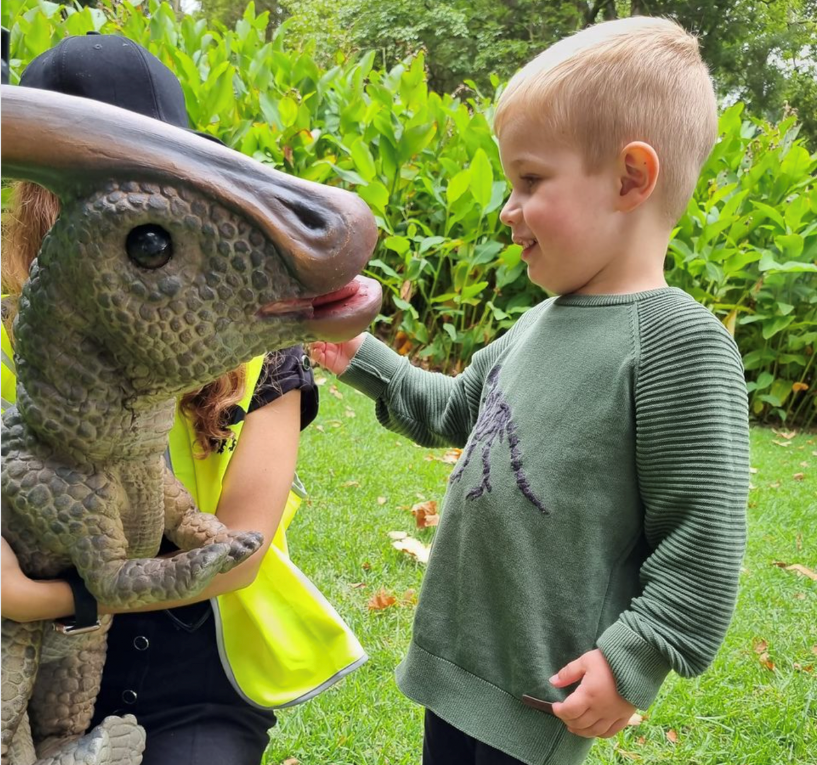 boy with small dinosaur