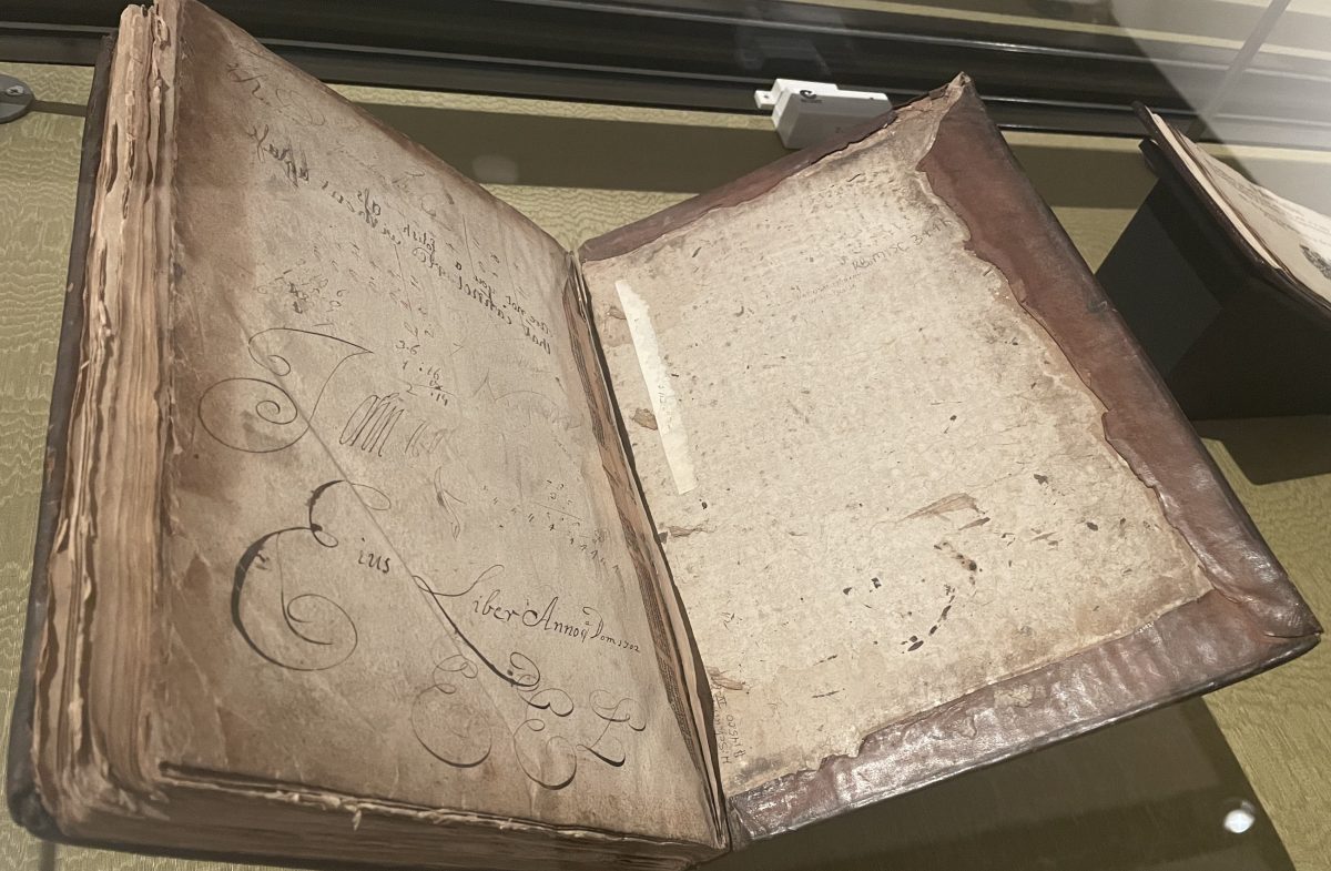 1669 book on display featuring annotations in mirror writing by schoolboys