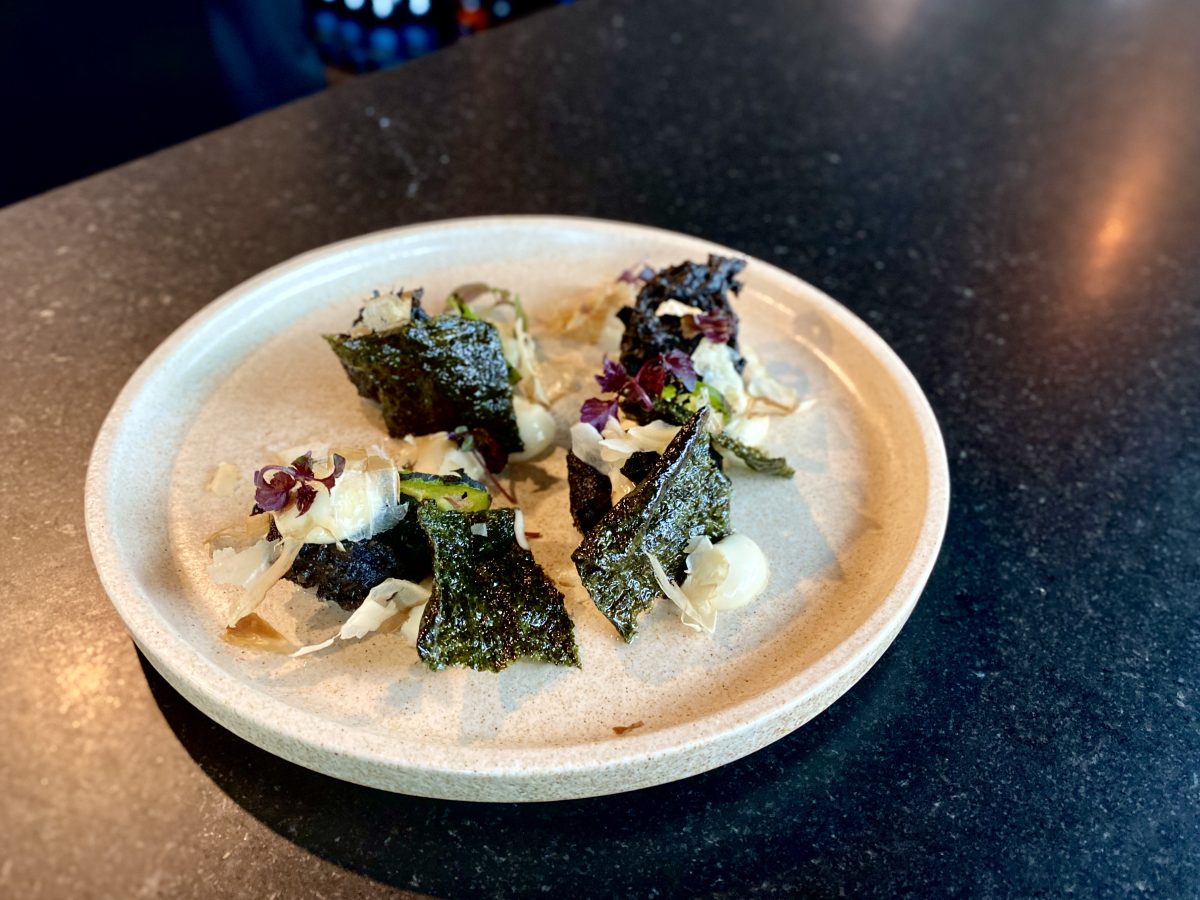 An unusual dish with pieces of seaweed and black tempura batter.