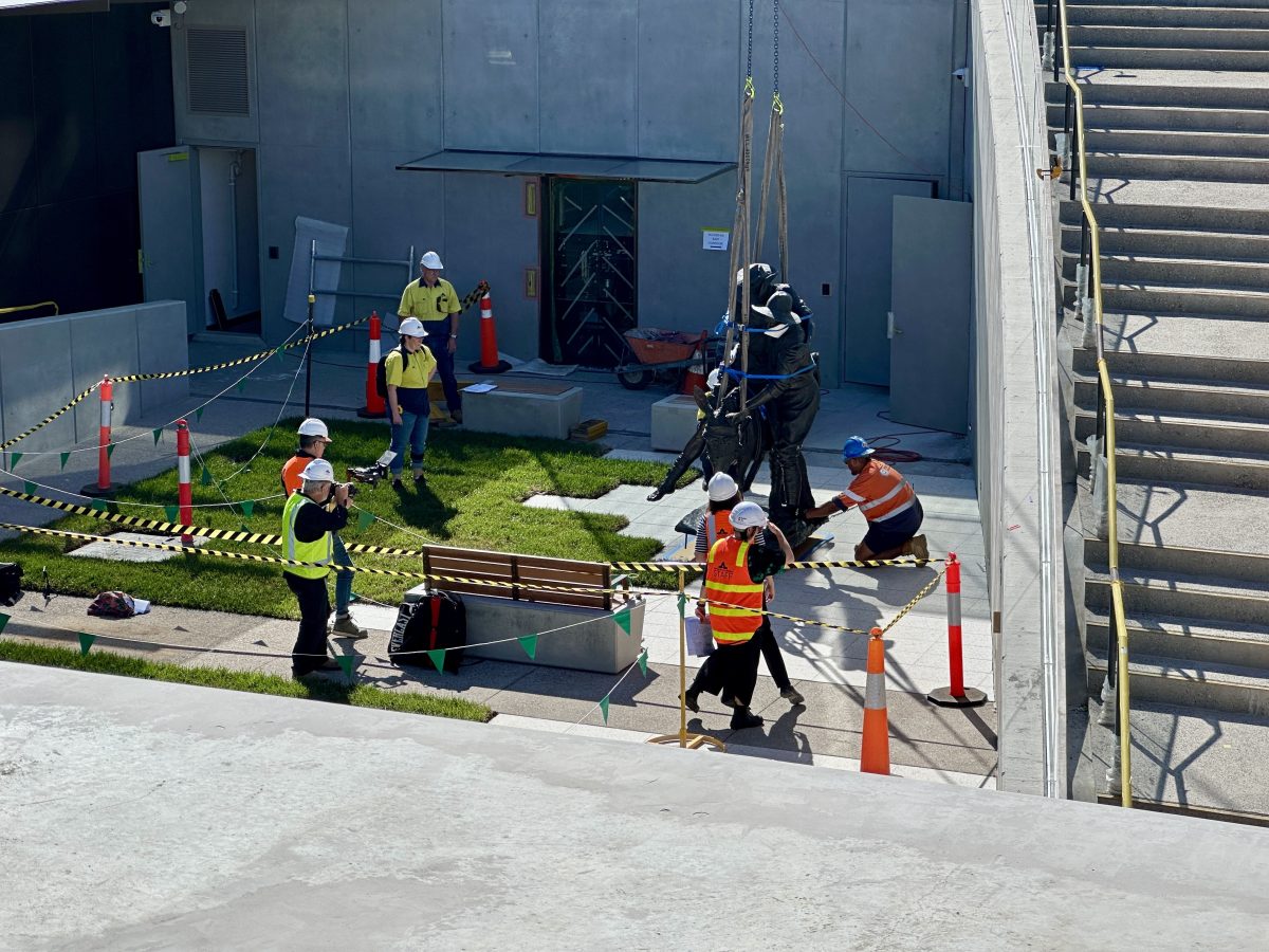 statue being lifted by a crane