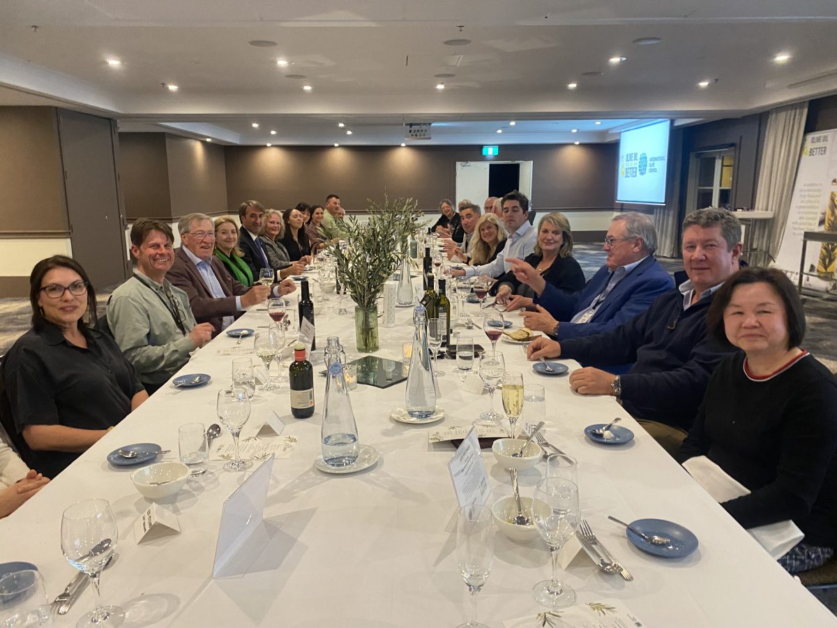 people sitting at a long table in a conference room