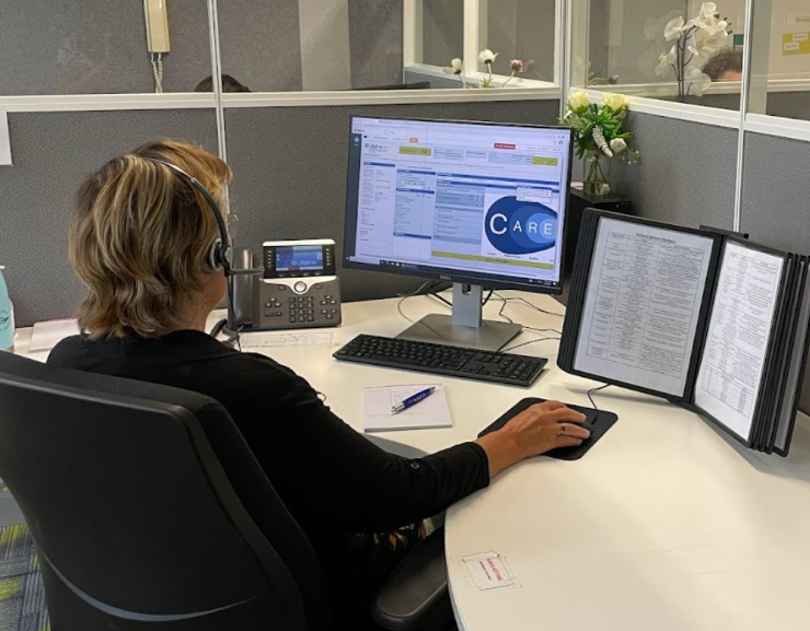 woman on phone at a computer