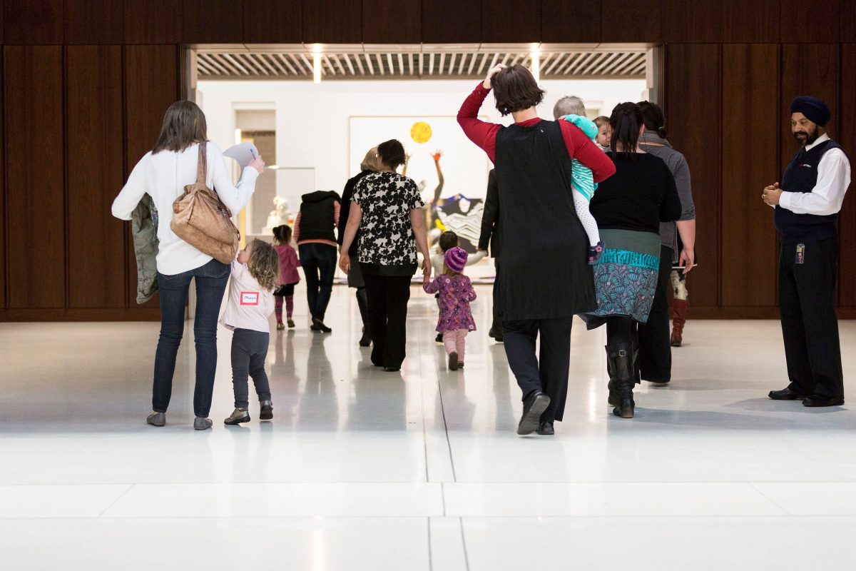 a group of people walking in the National Portrait Gallery