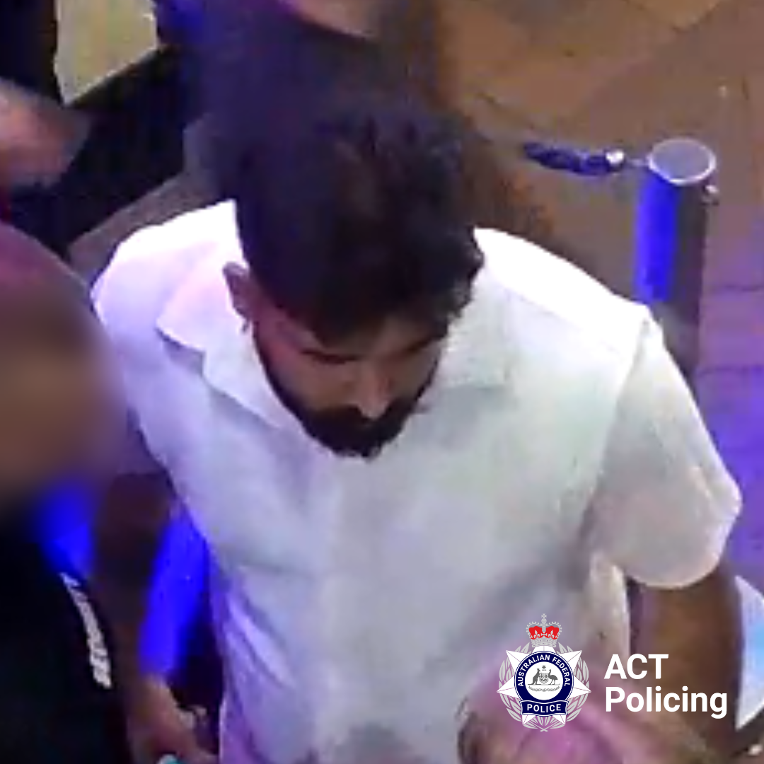 An image of a man wearing a white shirt in a nightclub