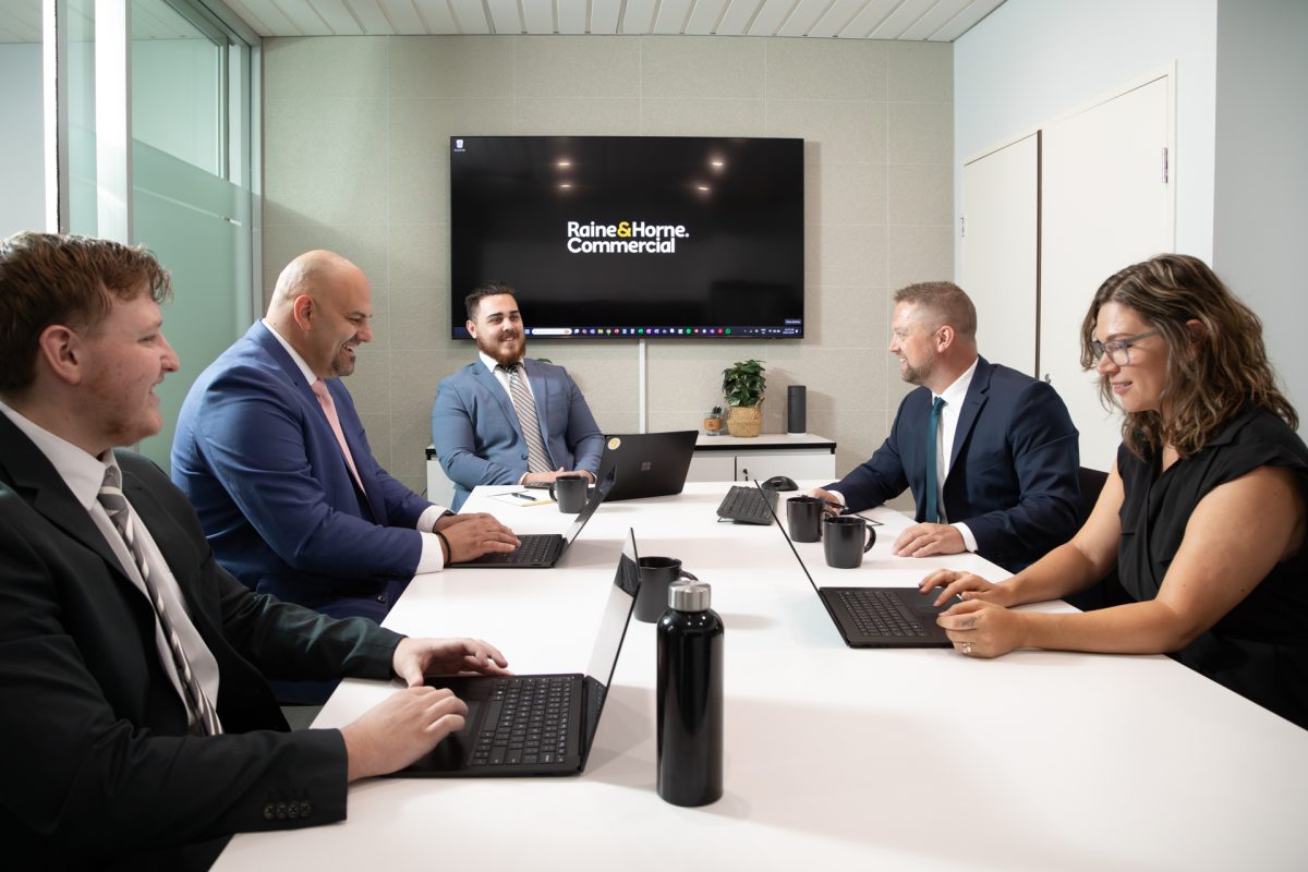 Staff members sitting in boardroom