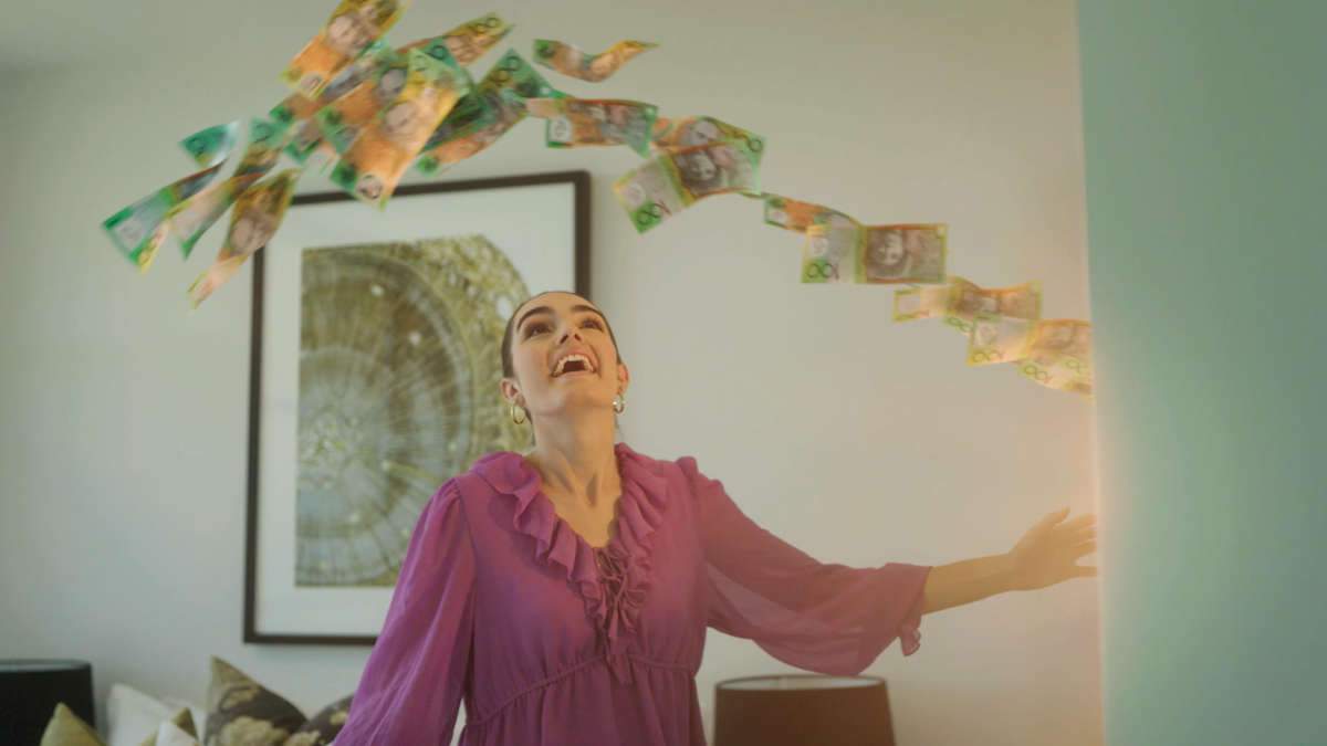 Woman opens a door and an arc of glowing $100 bills flies in