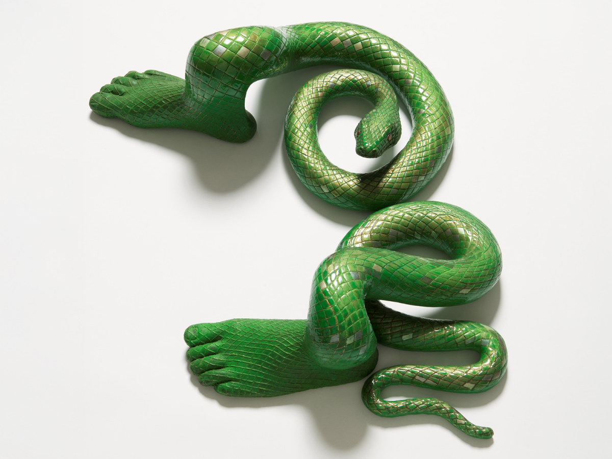 Sculpture of a green snake with emerald shaped scales with human feet