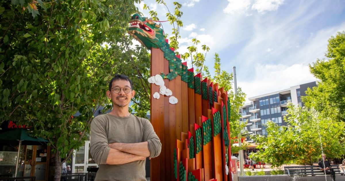  man and wooden dragon sculpture 