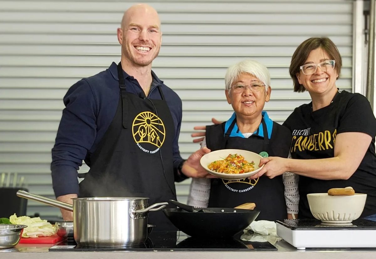 David Pocock with two women cooking