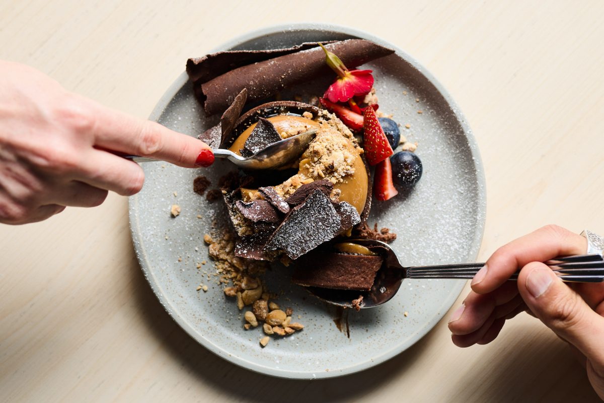 Two people sharing a dessert.