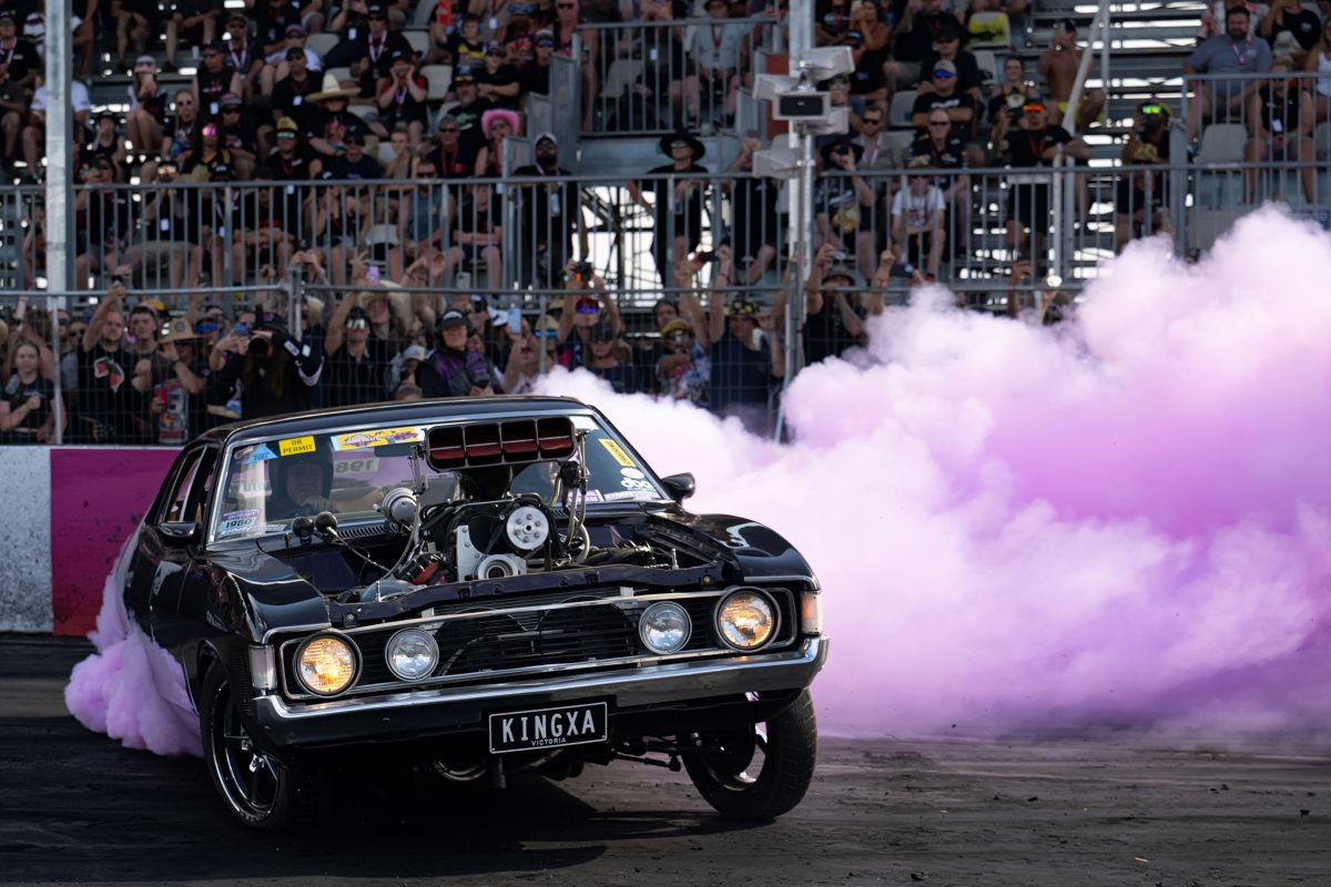 car doing a burnout with purple smoke