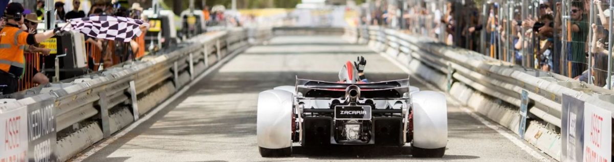 A photo of a sports car at the starting line of a racetrack 