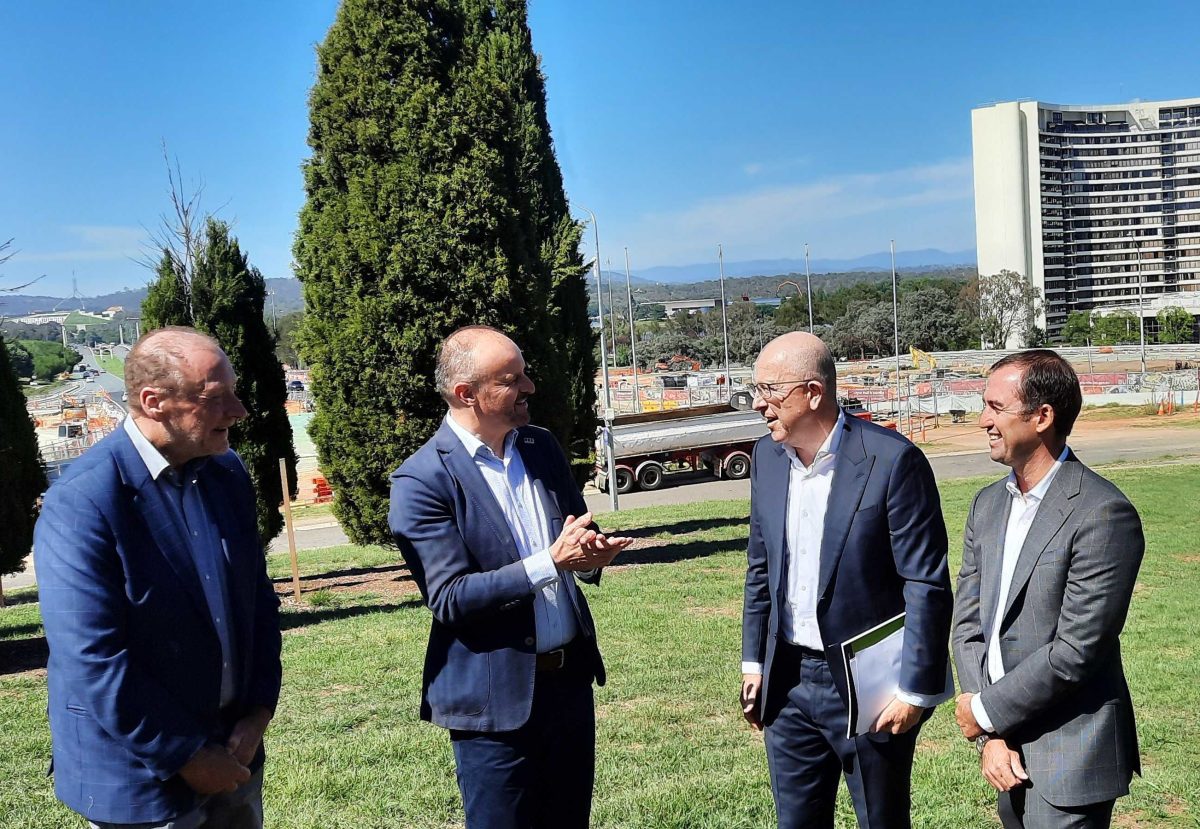 four men talking at a proposed development site