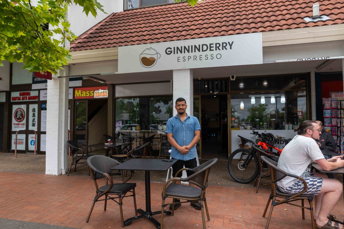 Man standing in front of a cafe