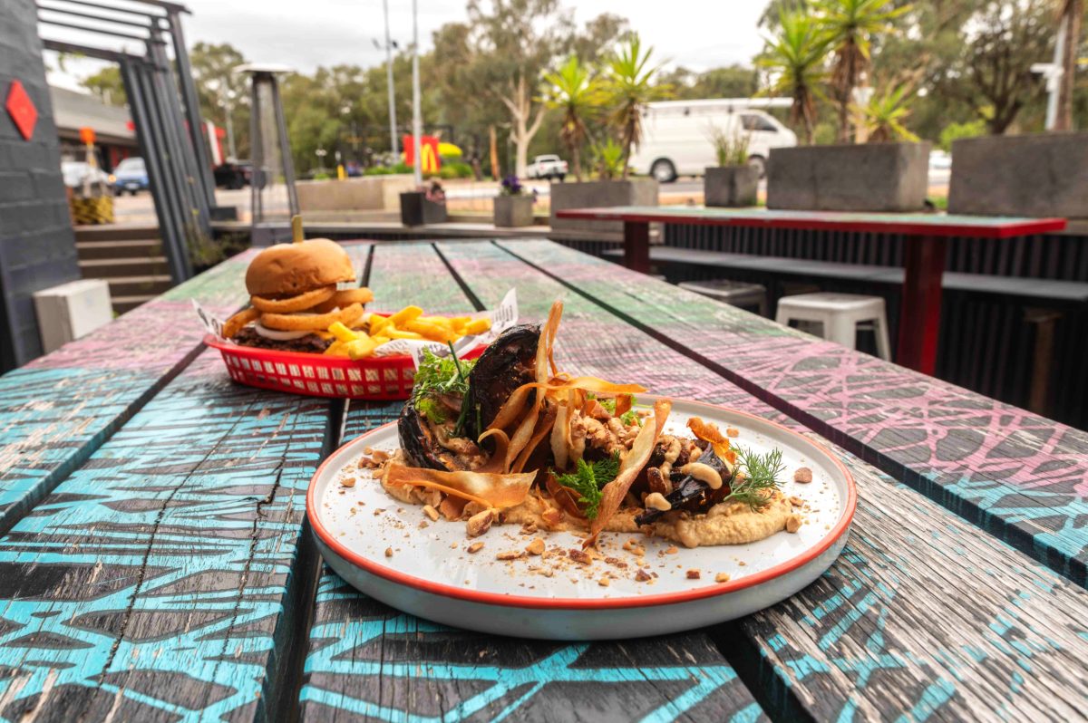 two plates of food on an outside table