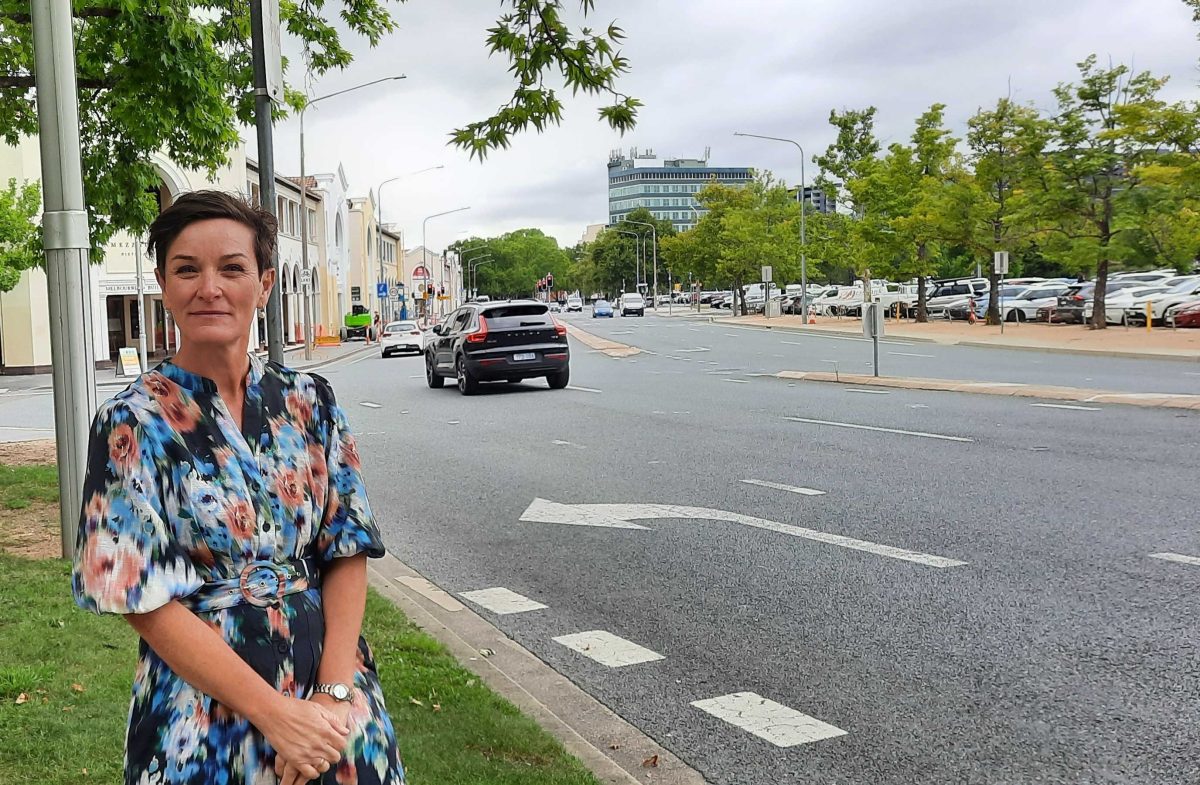 woman standing next to a road