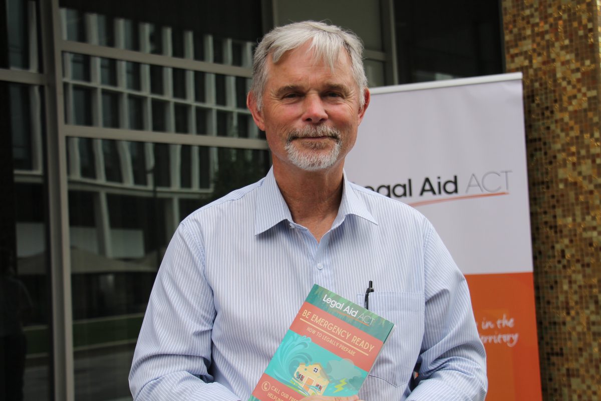  man looking at the camera and holding a booklet