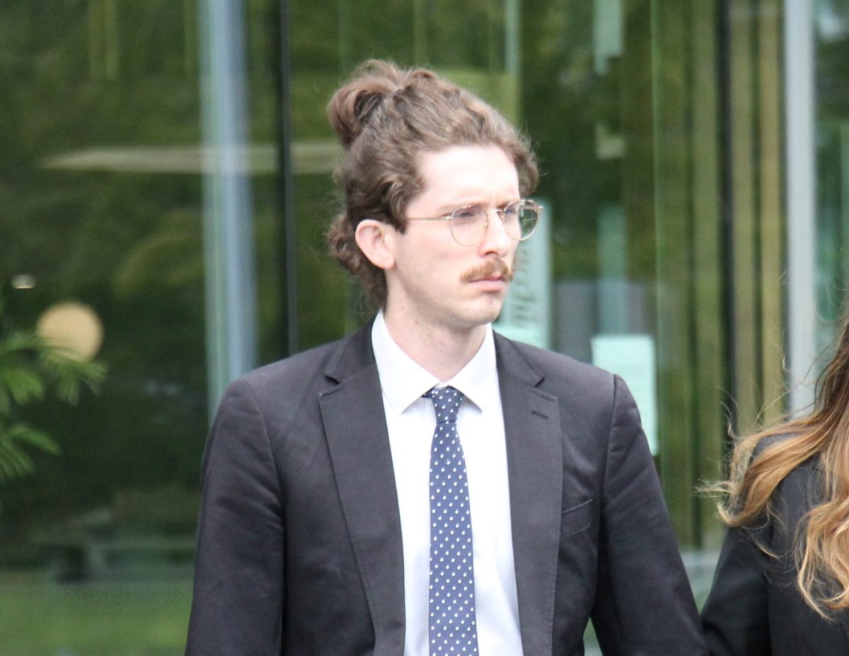 man with glasses outside court