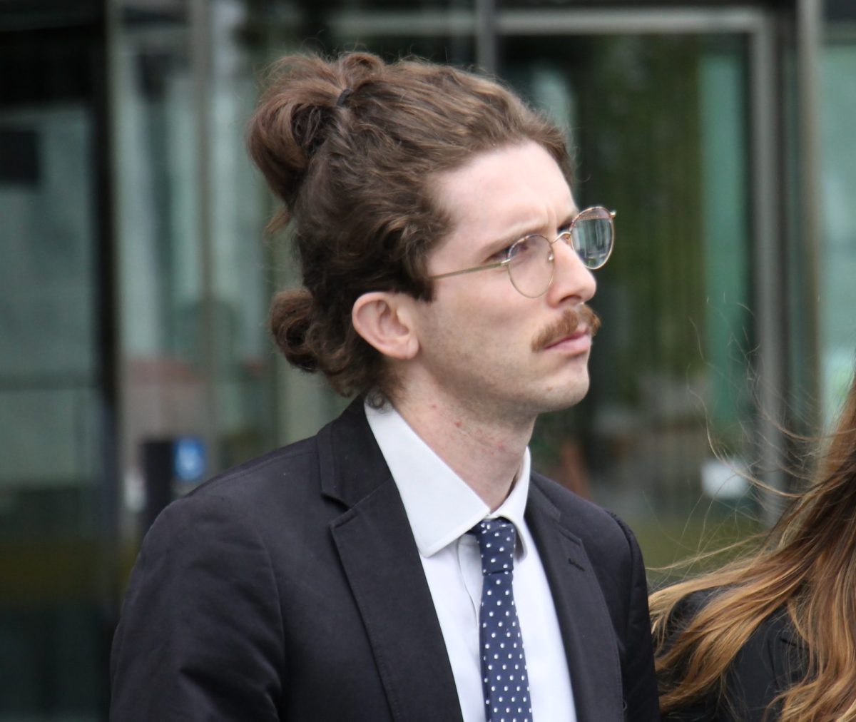 man with glasses outside court