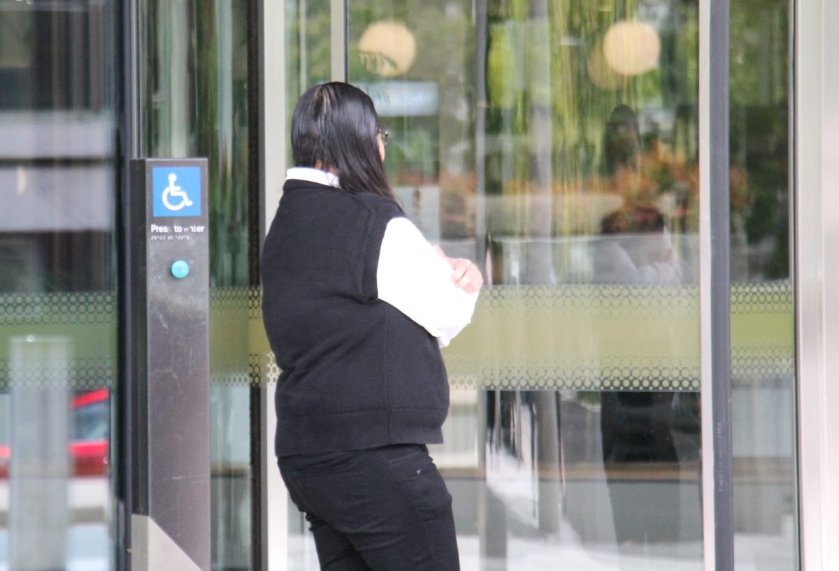 woman leaving court with her back to the camera