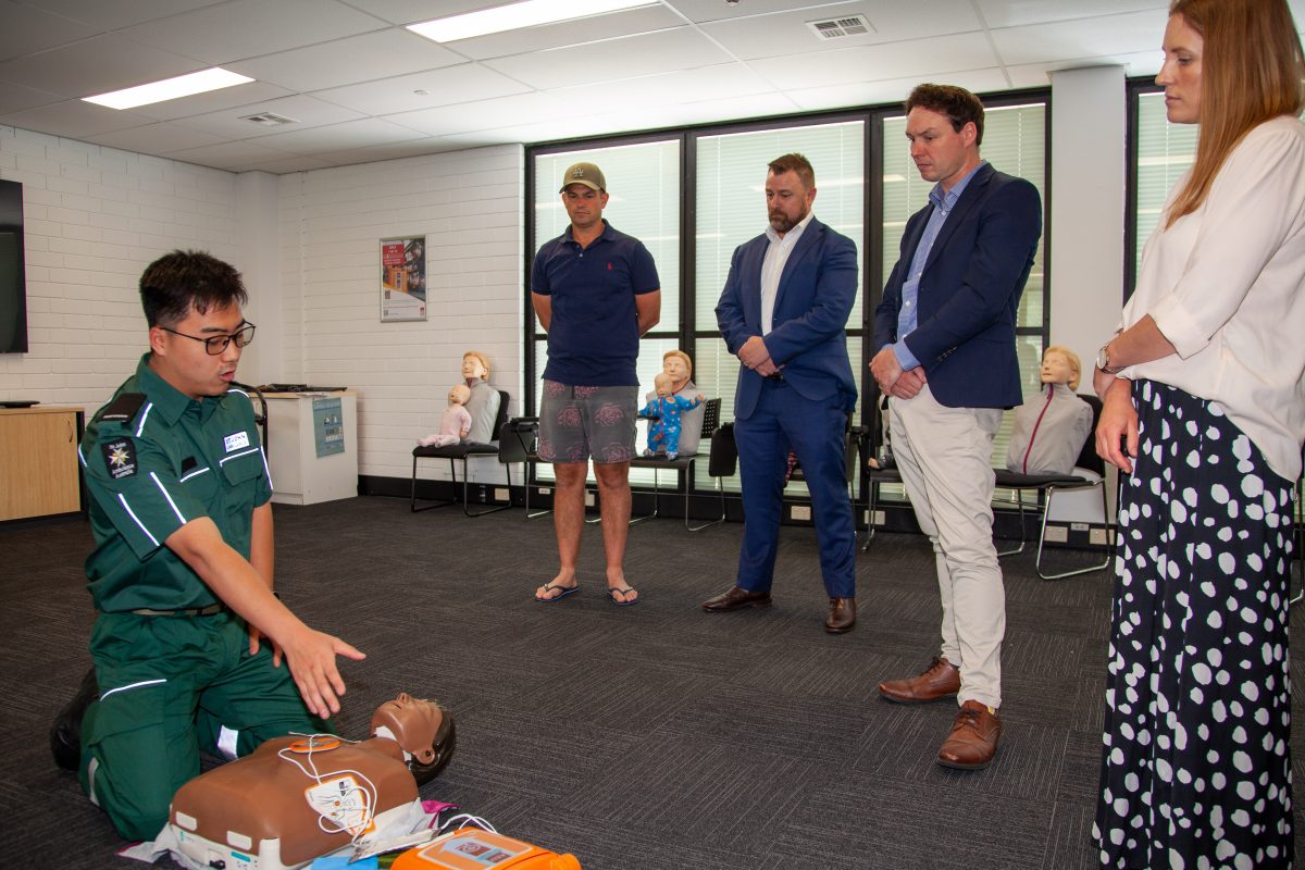 group CPR class with defibrillator