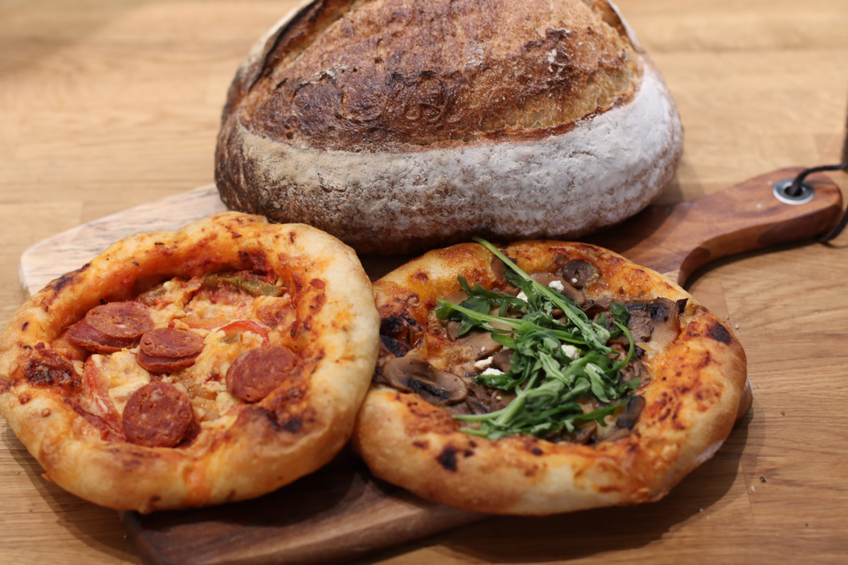 A loaf of sourdough and two pizzas