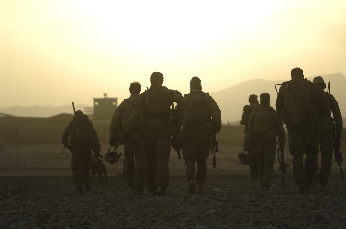 Troops walk with backs to camera 