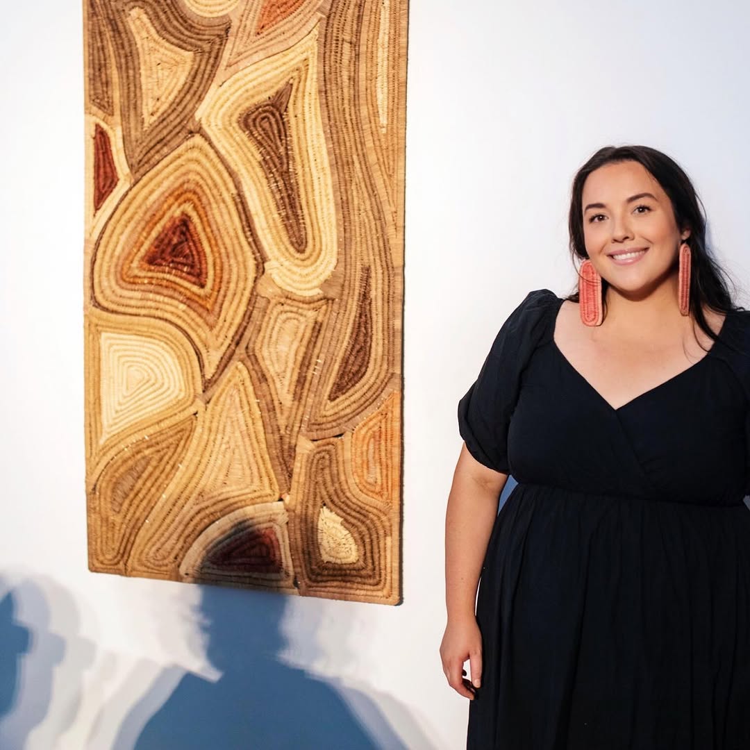 woman standing next to her art