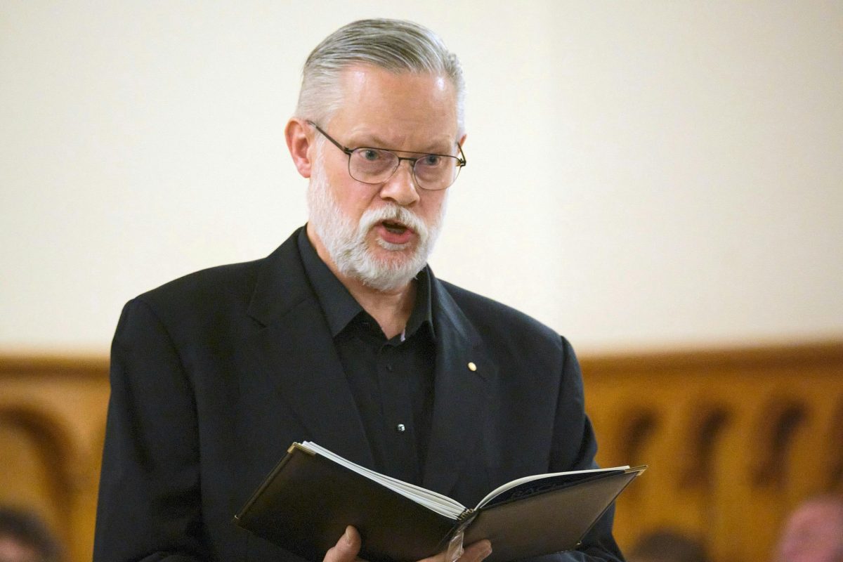 a photo of a vocalist singing bach at the bach ensemble performance