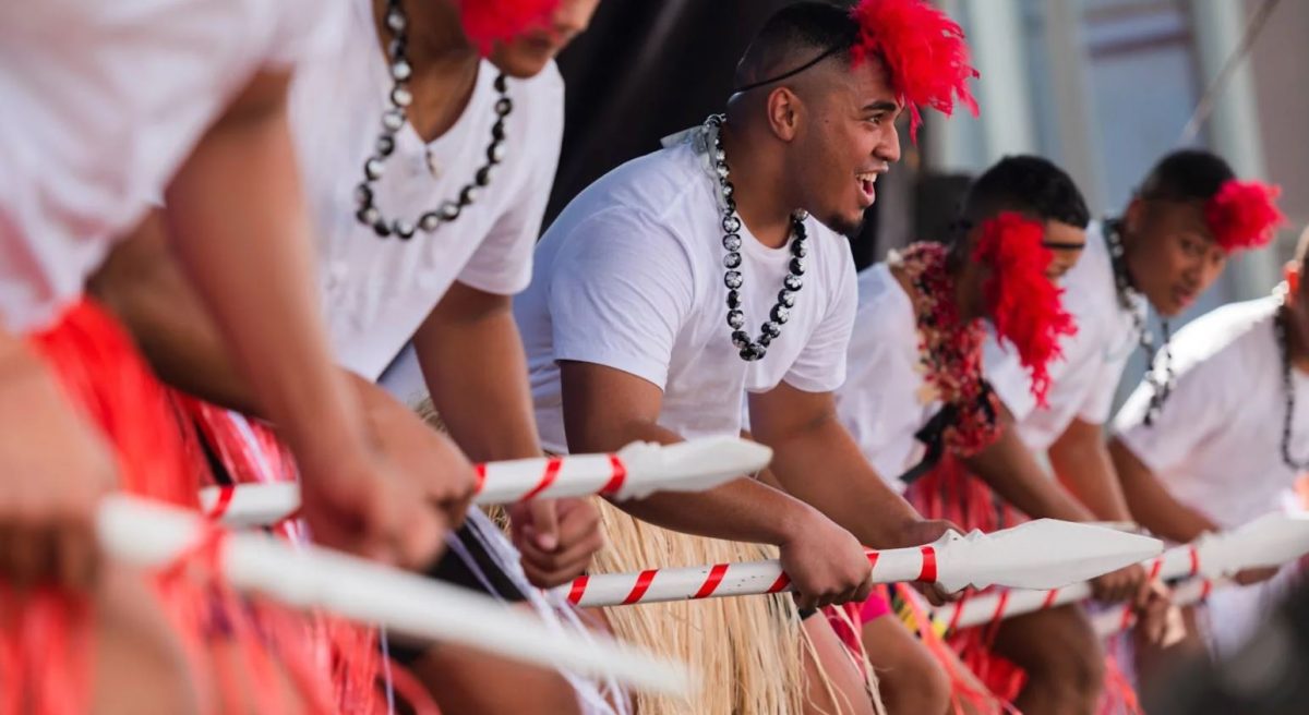 photo of men on stage performing a cultural dance 