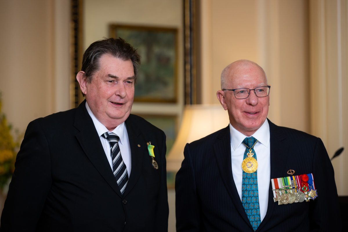 two men in suits with medals on their lapels