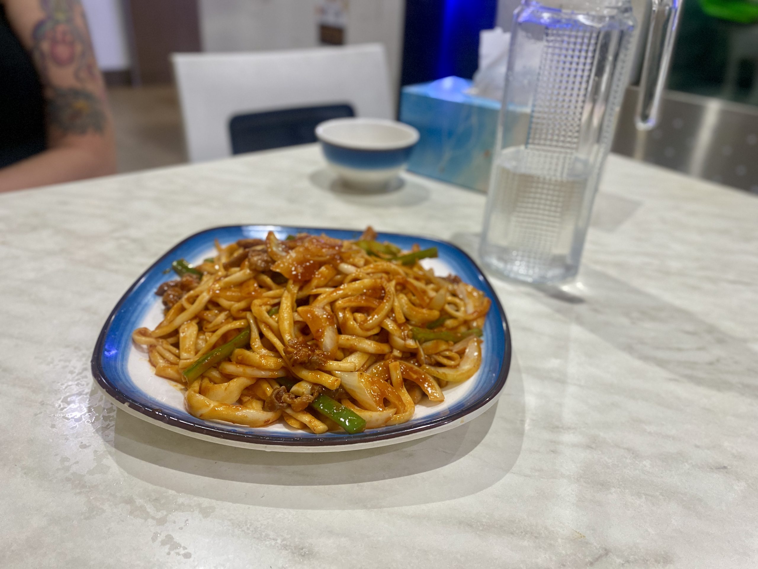 A plate of thick, shiny handmade noodles