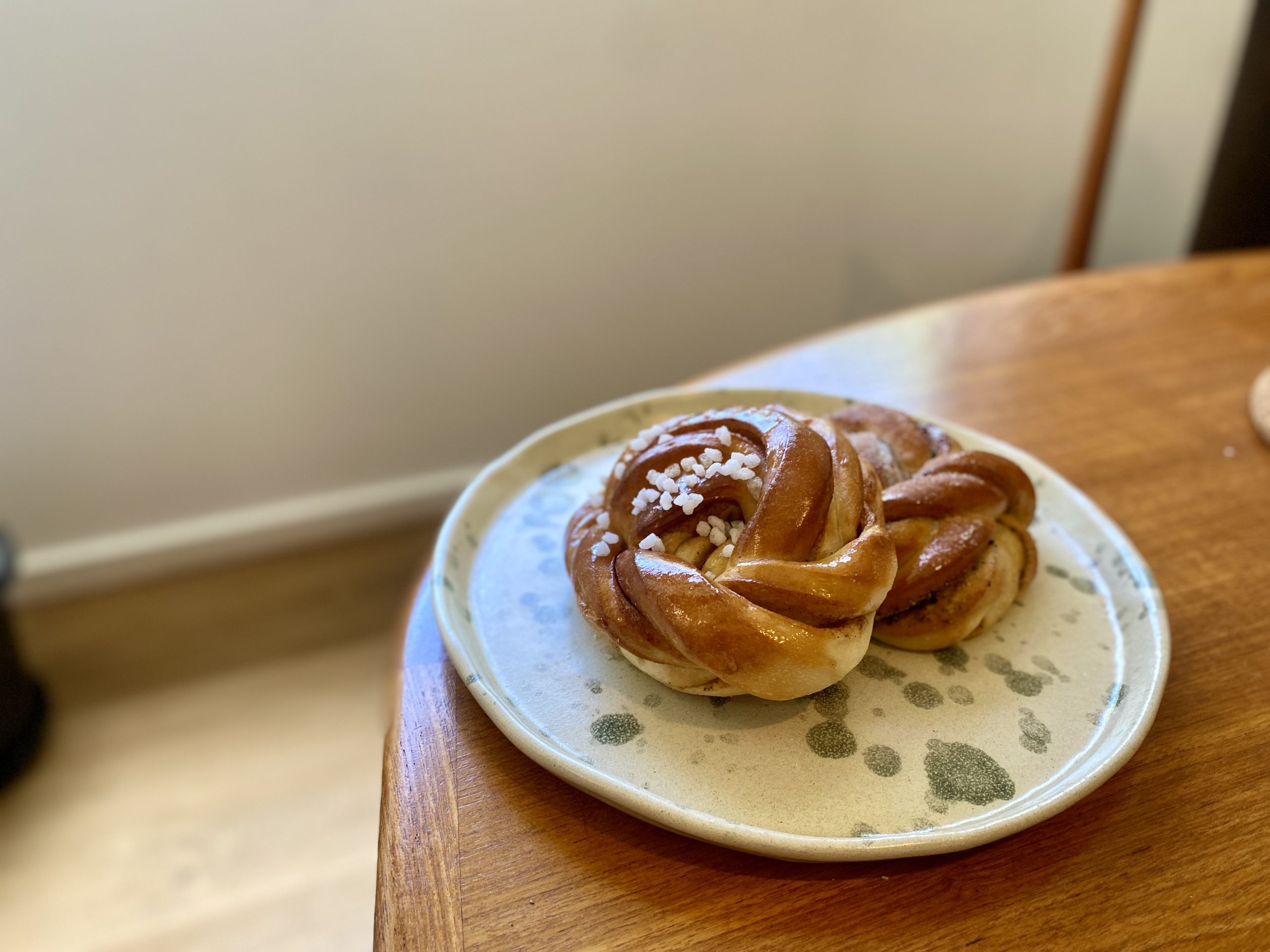 Two twisted buns on a plate.