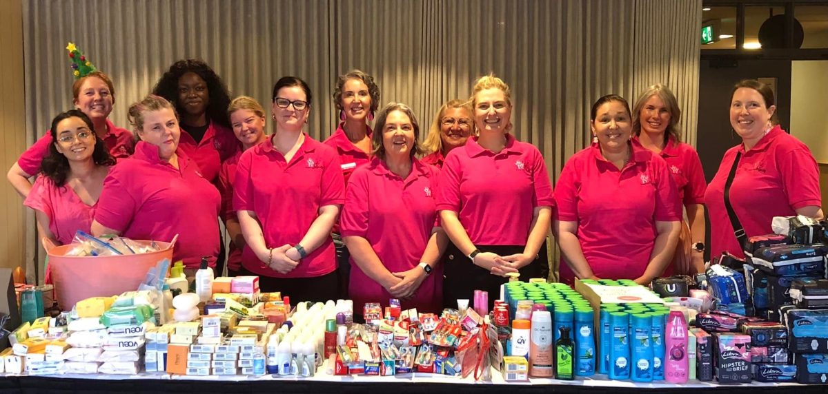 women smiling together at share the dignity packing party