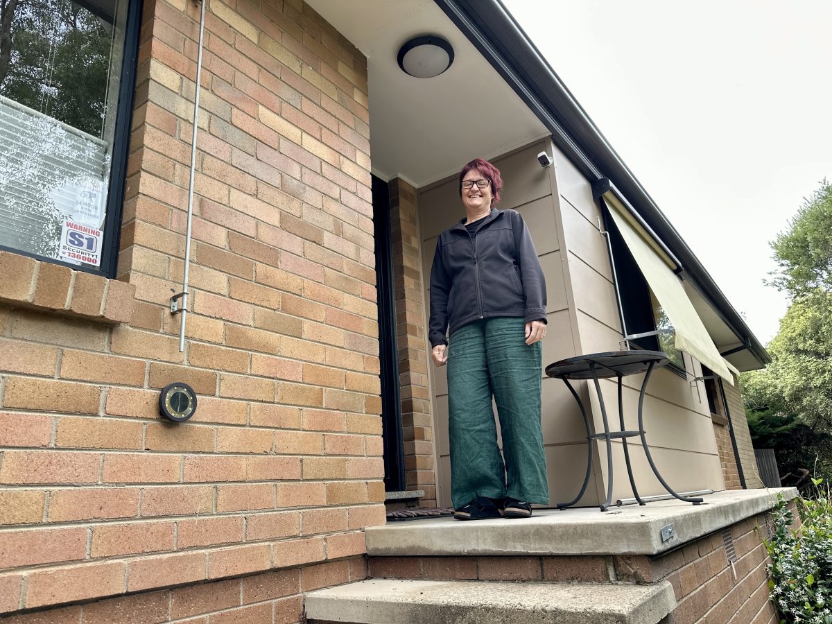 Woman posing at a house's doorstep