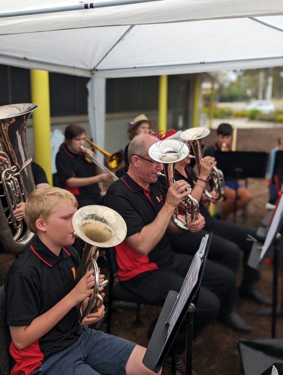 A group of people of different ages playing brass instruments