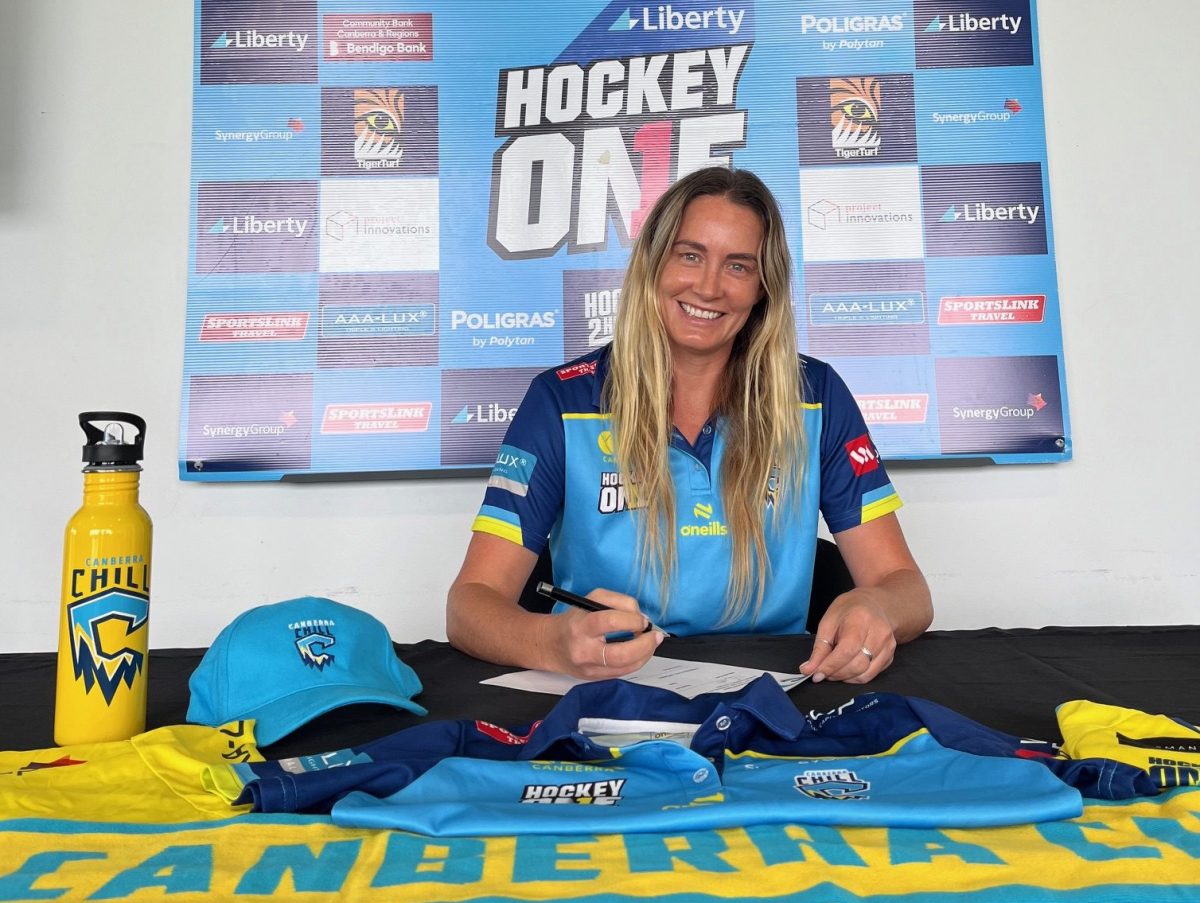 a woman signing a contract for a sports club