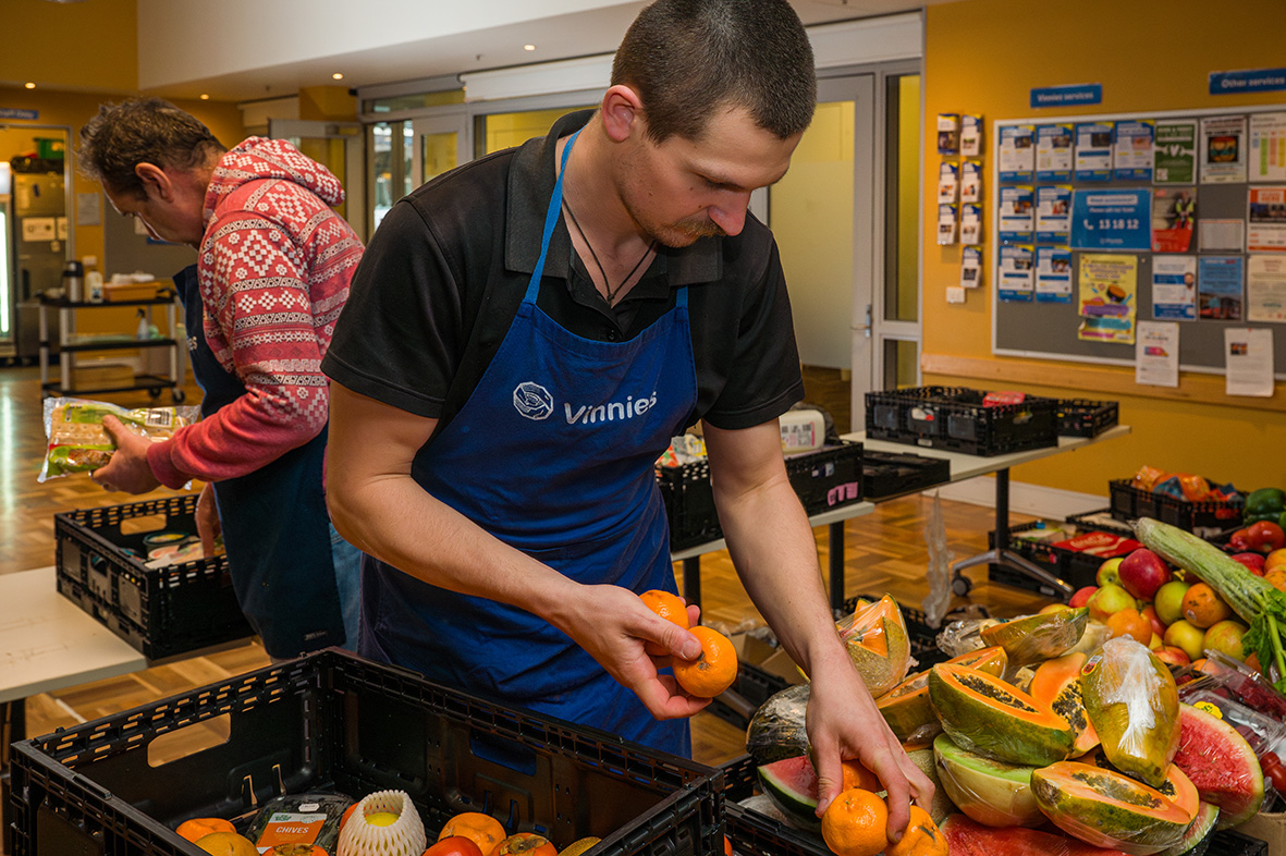 man packing food in a box