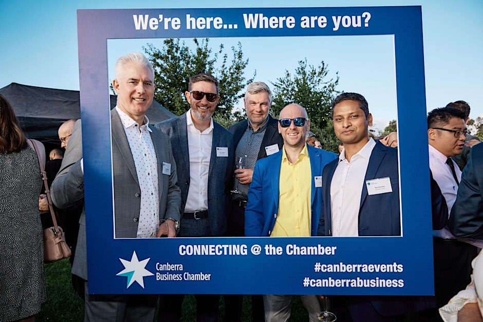 a group of people holding a selfie frame at a Canberra Business Chamber networking event