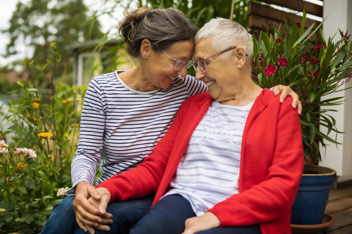 Senior woman with caregiver in the garden