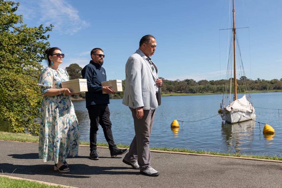 Moriori cultural leader Kiwa Hammond leads the way as Belinda Williamson and Jared Watty carry the ancestral remains to the handover ceremony.